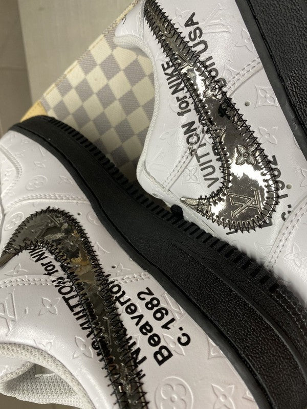 Side profile of Nike all-black sneakers retro runner design