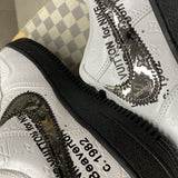 Side profile of Nike all-black sneakers retro runner design