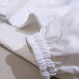 Close-up detail shot of Louis Vuitton luxury clothing with label-forward styling