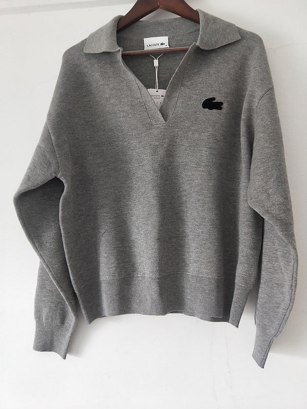Close-up detail shot of Lacoste luxury clothing with monogram-inspired silhouette