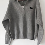 Close-up detail shot of Lacoste luxury clothing with monogram-inspired silhouette