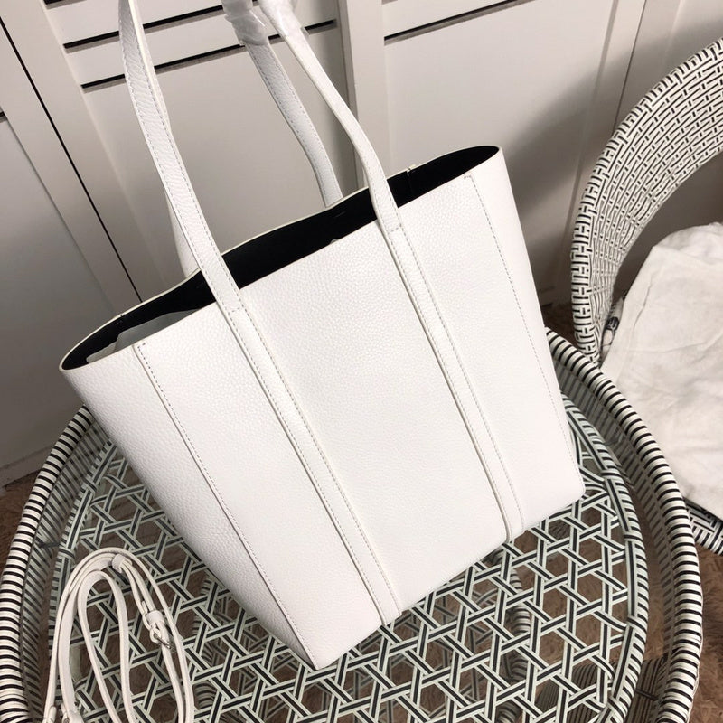 Handle and strap detail of structured elevated women's handbag – women's designer-style accessory