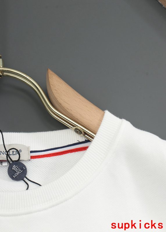 Flat lay presentation of Moncler luxury clothing with everyday silhouette