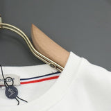 Flat lay presentation of Moncler luxury clothing with everyday silhouette