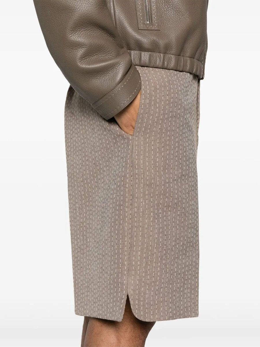 Close-up of Fendi pants hardware and fine stitching