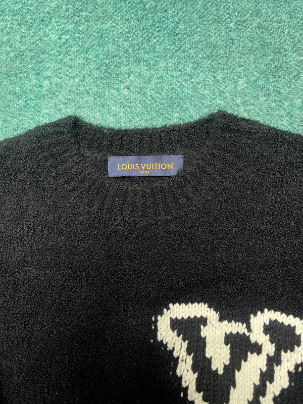 Close-up detail shot of Louis Vuitton luxury clothing with label-forward styling