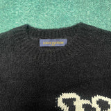 Close-up detail shot of Louis Vuitton luxury clothing with label-forward styling