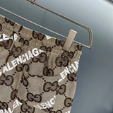 Close-up detail shot of Gucci luxury clothing with monogram-inspired silhouette