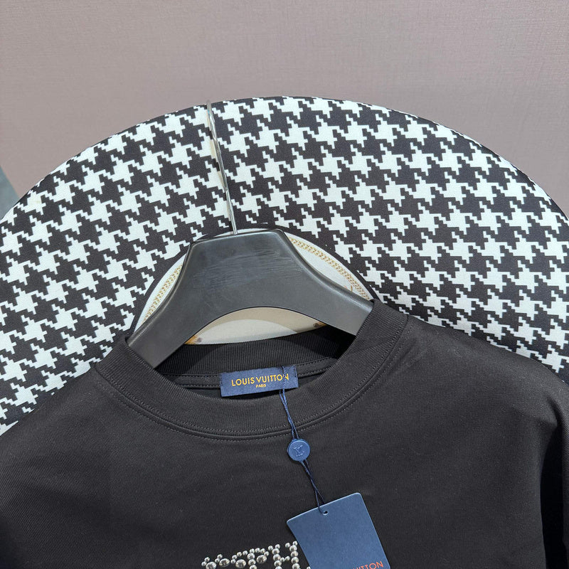Flat lay presentation of Louis Vuitton cotton t-shirt with monogram-inspired silhouette