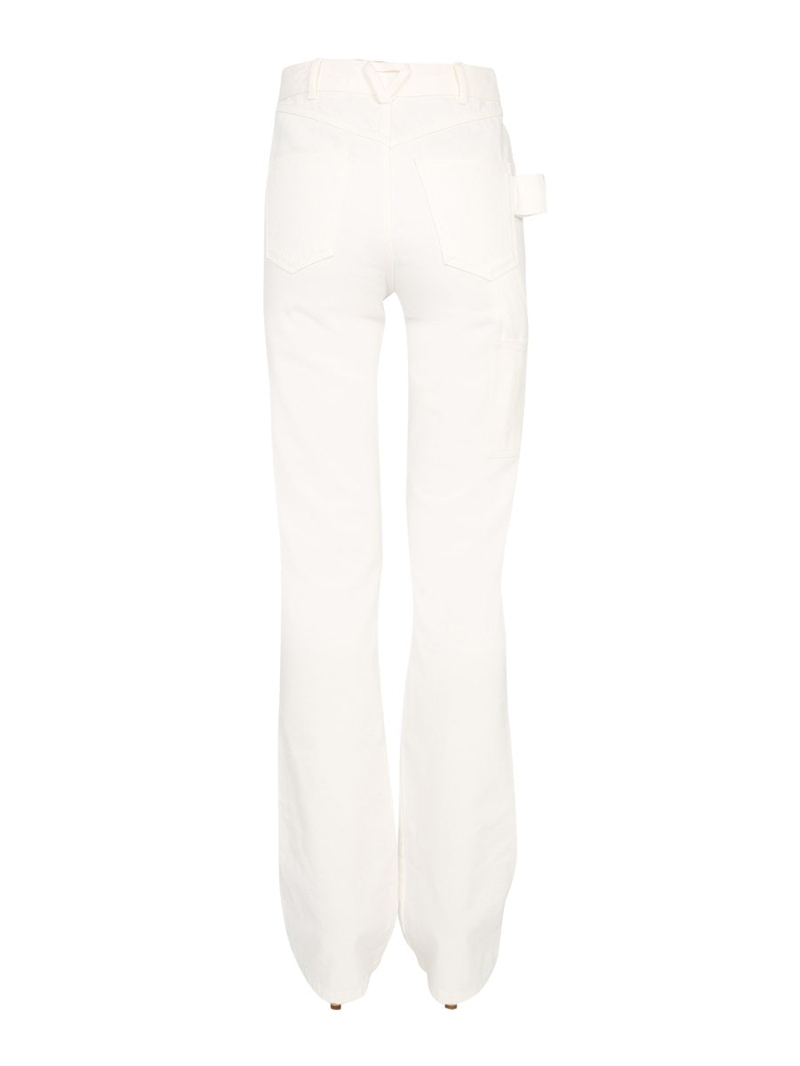 Close-up of Bottega Veneta pants hardware and fine stitching