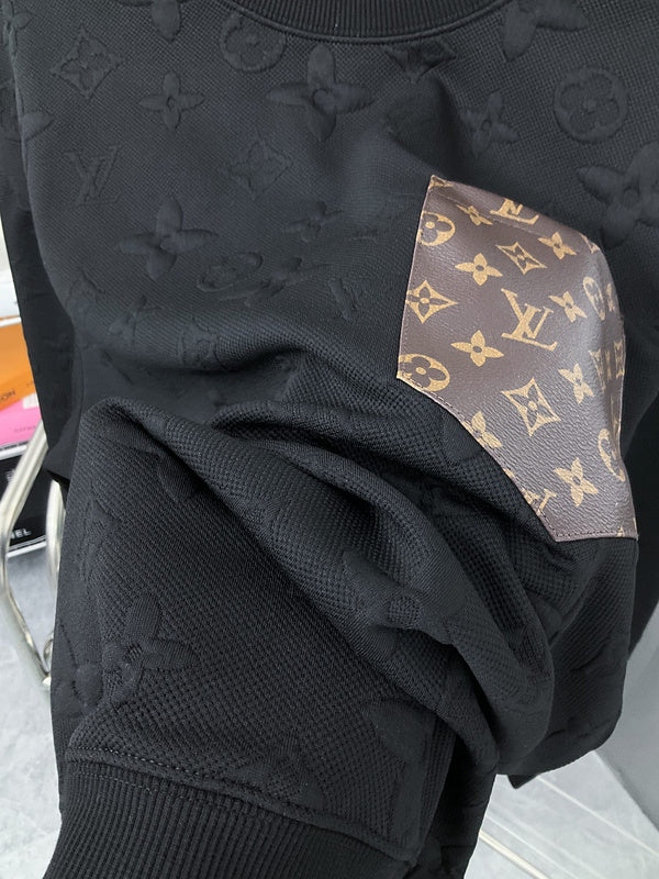Flat lay presentation of Louis Vuitton luxury clothing with runway-inspired design