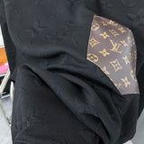 Flat lay presentation of Louis Vuitton luxury clothing with runway-inspired design