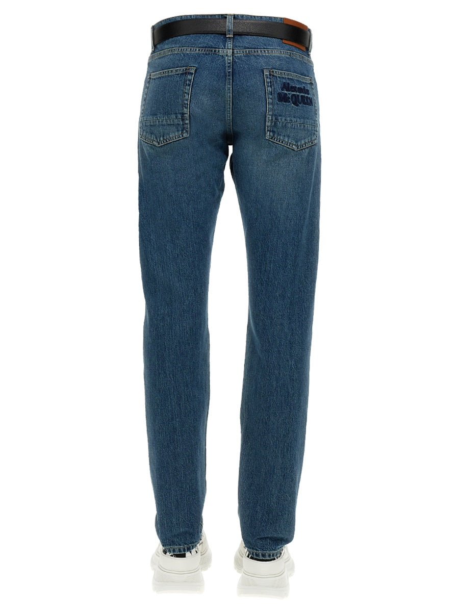 Close-up of Alexander McQueen pants hardware and fine stitching