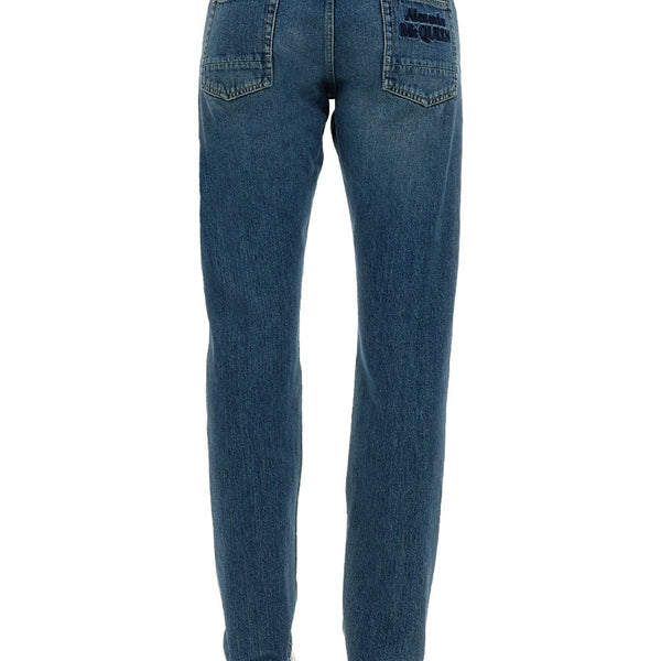 Close-up of Alexander McQueen pants hardware and fine stitching