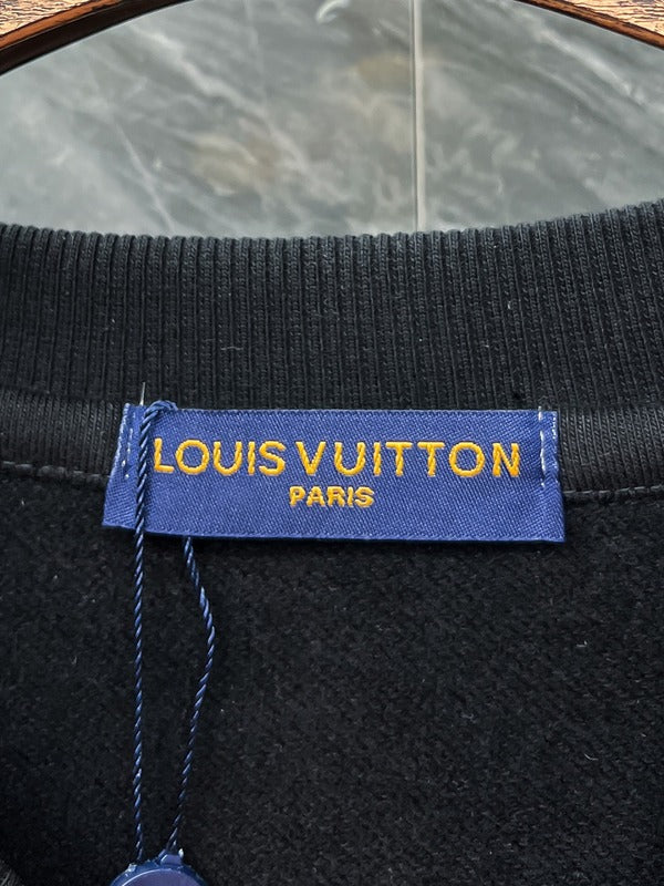 Side profile of Louis Vuitton luxury clothing with signature branding