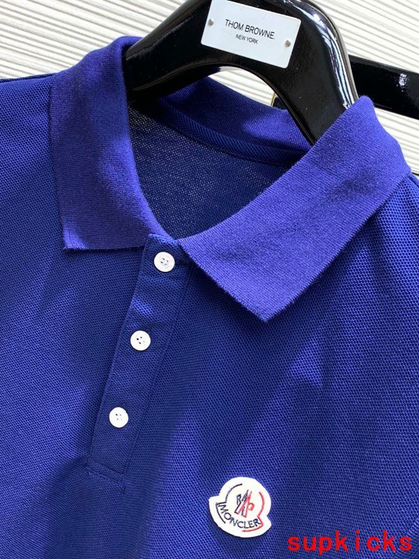 Close-up detail shot of Moncler luxury clothing with signature branding