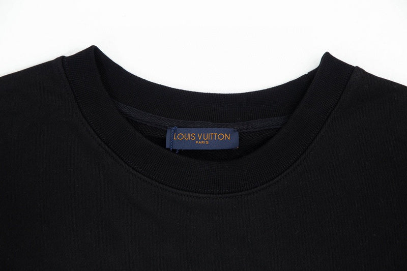 Flat lay presentation of Louis Vuitton luxury clothing with signature branding