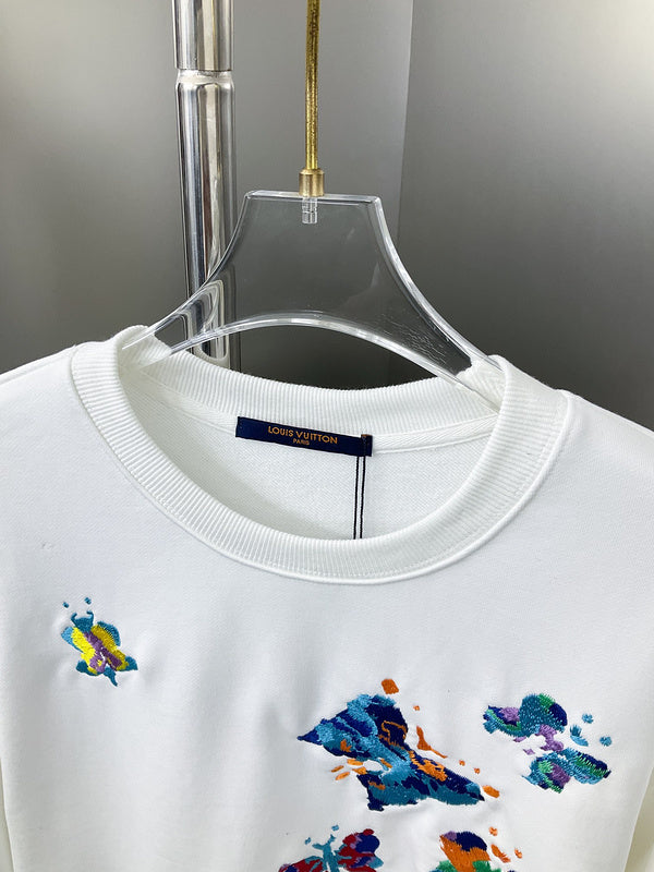 Close-up detail shot of Louis Vuitton luxury clothing with label-forward styling