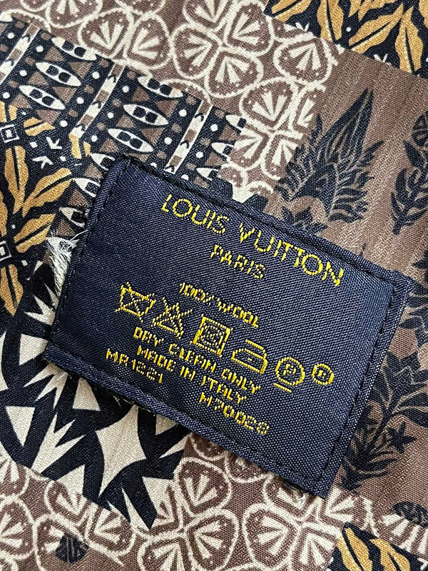 Flat lay presentation of Louis Vuitton luxury clothing with logo-detail design