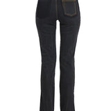 Close-up of Alexander McQueen pants hardware and fine stitching