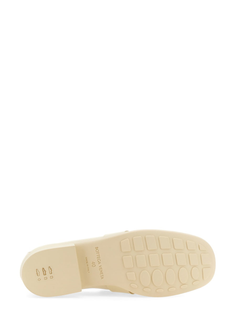 Close-up of Bottega Veneta slides hardware and fine stitching