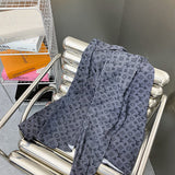 Close-up detail shot of Louis Vuitton luxury clothing with label-forward styling