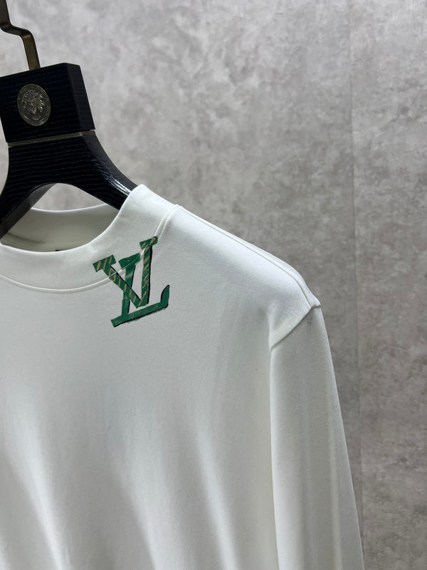 Flat lay presentation of Louis Vuitton luxury clothing with monogram-inspired silhouette