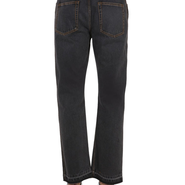 Close-up of Alexander McQueen pants hardware and fine stitching