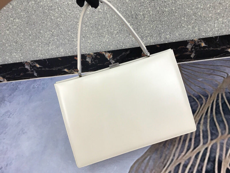 Styled lifestyle shot of refined classic women's handbag – women's everyday handbag