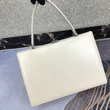 Styled lifestyle shot of refined classic women's handbag – women's everyday handbag
