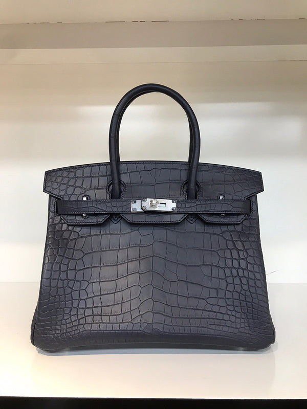Side view of poised structured handbag