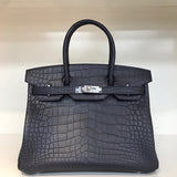 Side view of poised structured handbag