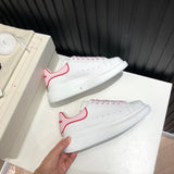 Side profile of Alexander McQueen crisp white sneakers everyday casual design
