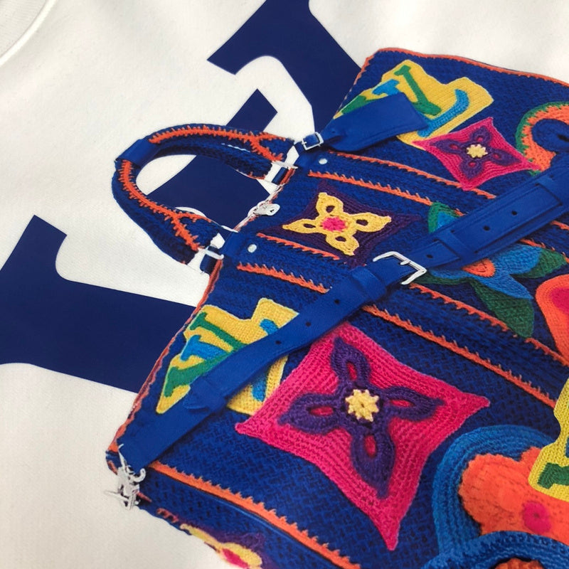 Flat lay presentation of Louis Vuitton luxury clothing with signature branding