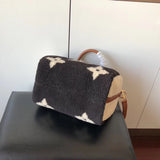 Side profile of signature premium women's handbag – women's statement bag