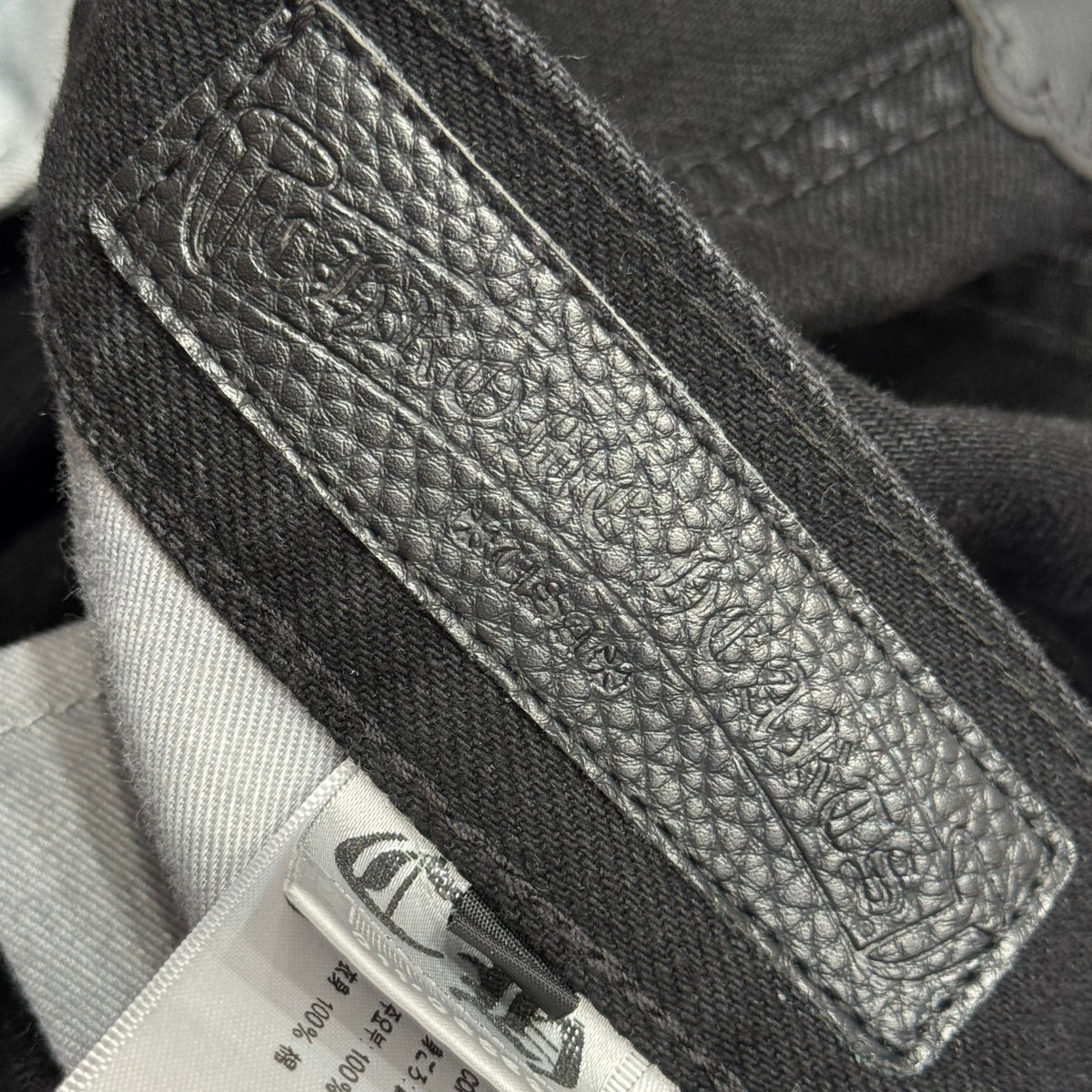 Detail shot of Chrome Hearts Jeans premium leather texture