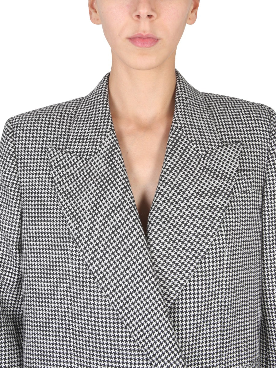 Close-up of Alexander McQueen coats hardware and fine stitching