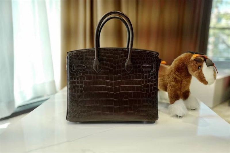 Side view of classic structured handbag