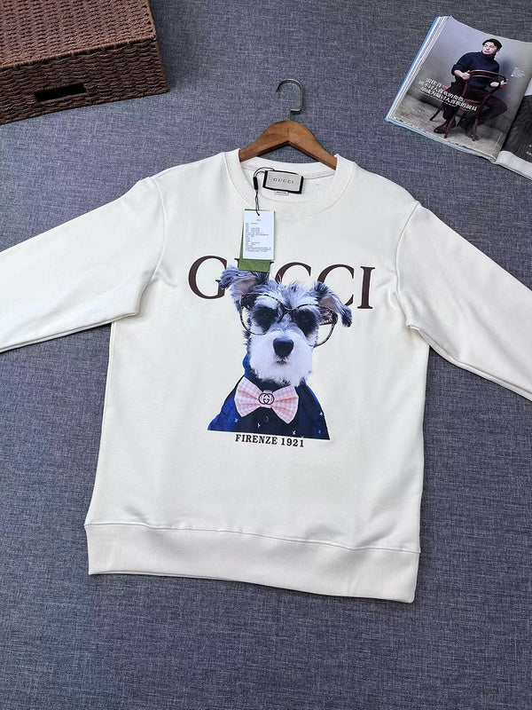 Flat lay presentation of Gucci luxury clothing with signature branding
