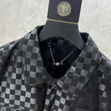 Close-up detail shot of Louis Vuitton luxury clothing with label-forward styling