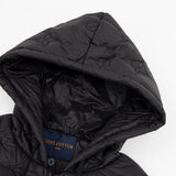 Close-up detail shot of Louis Vuitton luxury clothing with monogram-inspired silhouette