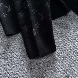 Side profile of Louis Vuitton luxury clothing with logo-detail design
