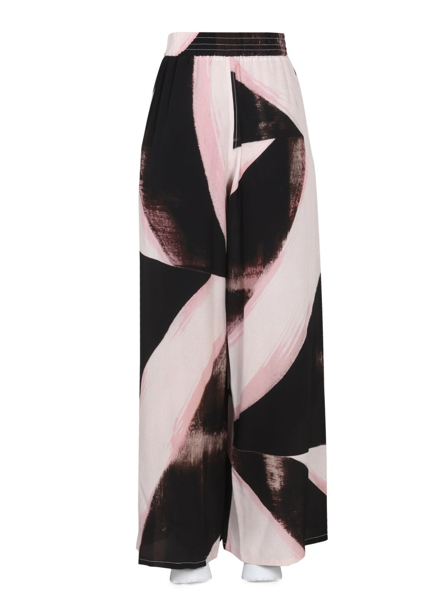 Close-up of Alexander McQueen pants hardware and fine stitching