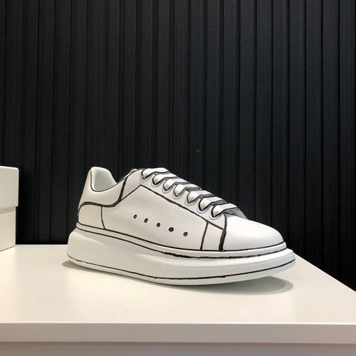 Side profile of Alexander McQueen soft grey sneakers chunky sole construction