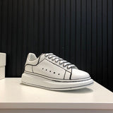 Side profile of Alexander McQueen soft grey sneakers chunky sole construction