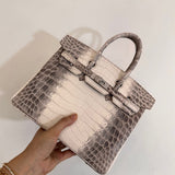  Statement crossbody bag carried on shoulder