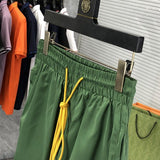 Flat lay presentation of Rhude luxury clothing with label-forward styling