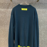 Back view of Louis Vuitton luxury clothing with label-forward styling