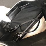 Side profile of statement structured women's handbag – women's luxury accessory