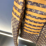 Flat lay presentation of Louis Vuitton luxury clothing with runway-inspired design